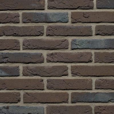waalformaat steenstrips bruin zwart genuanceerd op een binnenshuis muur