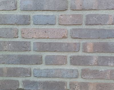 metselstenen waalformaat grijsbruin op gemetselde muur