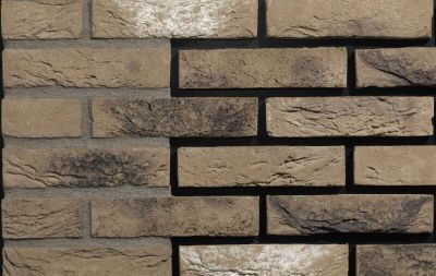 taupe metselstenen waalformaat in wildverband op een buitenmuur